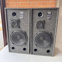 Pair of Audio Tech Pro Series speakers front view showing grille, drivers, and logos