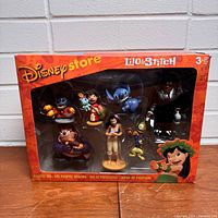 Front view of original boxed toy set showing all seven character figures from Disney's Lilo and Stitch in sealed window box.