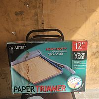 Box of Quartet 12-inch paper trimmer with image of the product and key features.