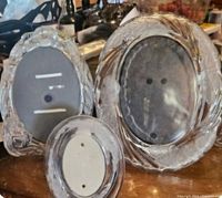 Three oval glass picture frames of different sizes with textured glass edges.