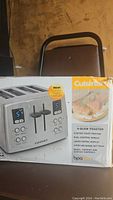 Box showing Cuisinart Custom Classic 4-slice toaster with new custom toast feature.