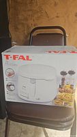 T-fal deep fryer in its original box showing the product image and brand name on the packaging.