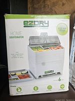 Box packaging of Ez Dry home dehydrator showing the product image, usage instructions, and features including six trays and recipe book.