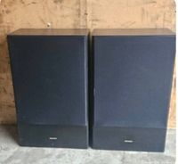 Front view of the two Genexxa GX1500 speakers showing fabric grille and exterior condition