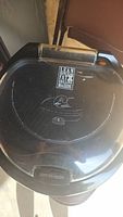 Top view of the closed grill showing the 'Lean Mean Grilling Machine' logo and George Foreman signature on plastic lid with visible crack.