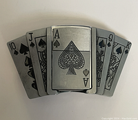 Front view of metal belt buckle designed as five playing cards with Ace of spades lighter in center.