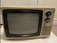 Front view of the beige Electrohome vintage television with CRT screen and tuning knobs on the right side.