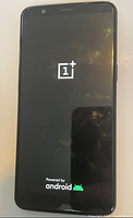 Front display showing OnePlus logo and Android boot screen, phone powered on