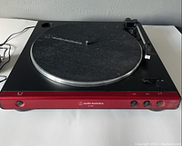 Audio-Technica AT-LP3 record player front view showing control buttons and felt platter mat with logo.