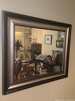 Front view of the rectangular mirror showing full reflective surface and dark metallic frame, hung on a wall.
