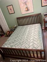 Assembled bed frame with mattress in bedroom setting