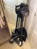 Both vacuums and accessories assembled in standing position against mirror