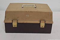 Closed view of beige and brown plastic tackle box, labeled 'Jandy V'.
