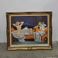 Front view of large gold framed painting showing three women seated and reclining on orange couch with dark night background.