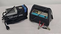 Black & Decker Air Station portable air compressor and EverStart WM-51A-PE battery charger side by side