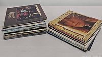 Two stacks of vintage vinyl record albums showing variety of sleeve artwork and titles including The Doobie Brothers and Bob Dylan albums.