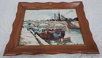 Full view of framed lithograph showing the boat and canal scene, wooden frame with scalloped edges
