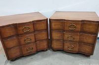 Pair of vintage Italian style solid wood nightstands with brass ring pull handles, showing front view of both pieces.