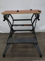 Front view of Black & Decker Workmate workbench showing wooden slats, black clamps, and metal frame