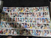 Top view photo showing 50 of the 1978 Topps baseball cards arrayed in rows and columns on a dark background.