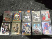 Photo showing all 10 Manny Ramirez cards laid out in two rows, each card in plastic sleeve, featuring various action and pose designs