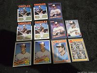Photo showing 11 Cal Ripken Jr. baseball cards from 1985 and 1986, including Orioles cards and All Star cards.