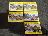 Five Topps baseball cards featuring Ken Griffey Jr. and Barry Bonds with yellow borders and images of the players.