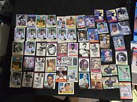Full spread of 54 vintage baseball cards laid out flat showing various players including Hall of Famers and all stars in various poses and card styles.