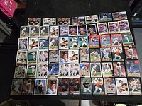 Overview of the 62 Cal Ripken Jr. baseball cards arranged on a surface showing various card designs and player poses.