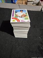 Stack of 1984 Topps baseball cards with Ron Guidry Yankees All-Star card visible on top, showing near mint condition and thickness of lot.