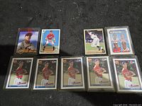 Photo of 9 Chipper Jones baseball cards, most in protective sleeves, showing various card designs and poses including individual portraits and a multi-player card.