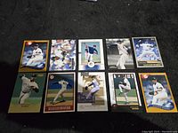 Ten baseball cards featuring Mariano Rivera arranged on black surface.
