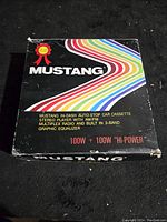 Top view of original Mustang box with rainbow stripes and model details for CRF-600B cassette stereo radio