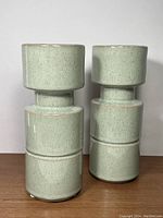 Pair of green glazed ceramic candle holders front view showing shape and size