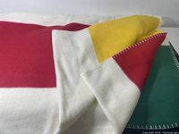 Close detail showing blanket folded back to reveal multiple Hudson Bay colored stripes and whipstitch edges.