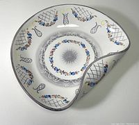 Top view showing the bowl's unique folded shape and decorative floral and lattice patterns with pastel colors and gold accents.