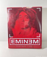 Front view of the book with red clear protective sleeve featuring Eminem's image and title.