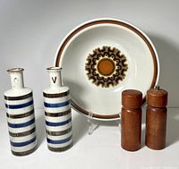 Front view showing two ceramic bottles, two teak shakers, and serving bowl with Aztec pattern.