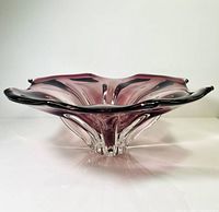 Side profile showing purple amethyst thick glass bowl with ruffled edge and clear glass base.