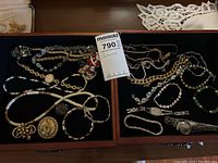 Two wooden trays displaying entire lot of jewelry pieces