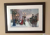 Full view of framed needlepoint showing city street winter scene with people, horse carriage, snow.