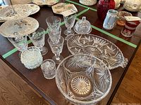 Full view of the assorted pinwheel pattern crystal pieces including various serving items and stemware on a table.
