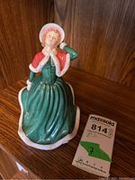 Front angled view showing the figurine's face, dress detail and pose.