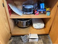 Hamilton Beach omelette maker, programmable slow cooker and kitchen wraps in cabinet shelf