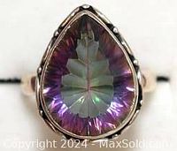 Front view showing pear-shaped Mystic Topaz gemstone with multi-color iridescence in silver setting.