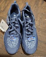 Top view of new Skechers women's sport shoes showing knit fabric design and tags.