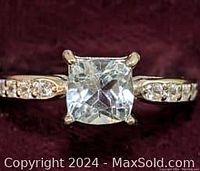 Close-up photo of the ring top showing the square-cut blue topaz center stone and cubic zirconia stones on the band.