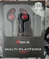 Front packaging showing red and black earbuds with gaming design, Xtrike Me brand, multi-platform, model GE-109
