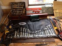 Workbench overview with wrench set, drill, jigsaw, socket set
