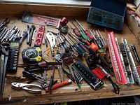 Overview of all tools spread on wooden workbench